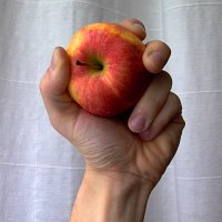 raised arm with apple